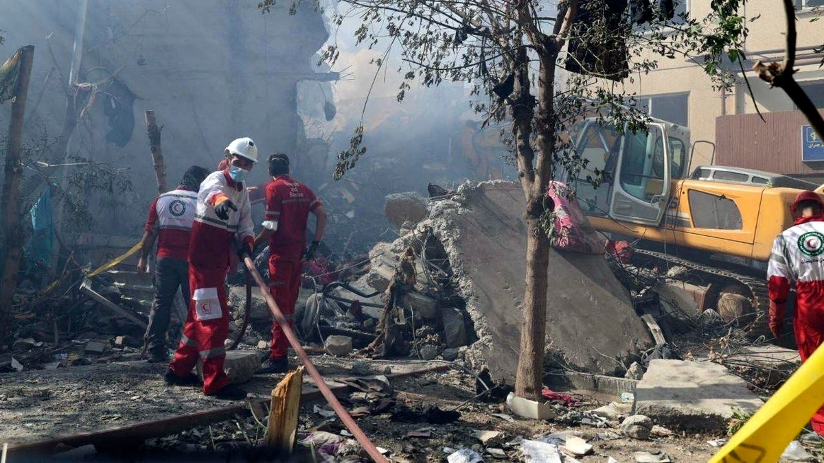 In this photo released by the Iranian Red Crescent Society, rescuers work at the scene of an explosion after an Israeli strike in Tehran, Iran, on Friday, June 13, 2025.