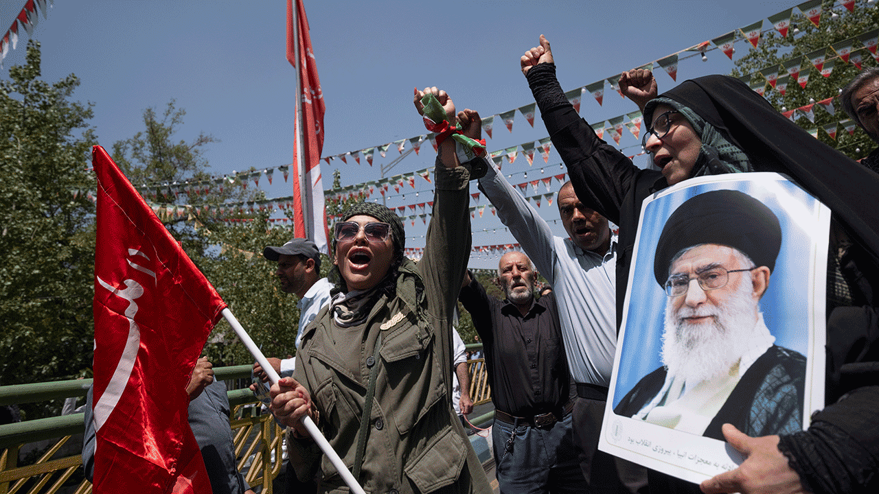 Iran demonstrators with a poster of Supreme Leader Ayatollah Ali Khamenei