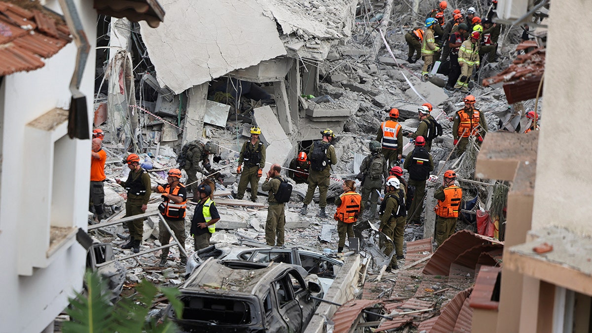 Rescuers dispersed amongst rubble