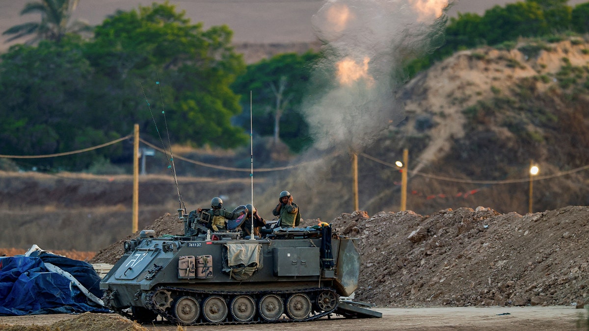 Israeli soldiers fire a mortar towards Gaza