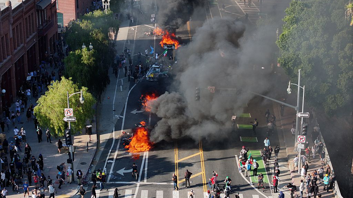 black smoke billows from road in LA during riot