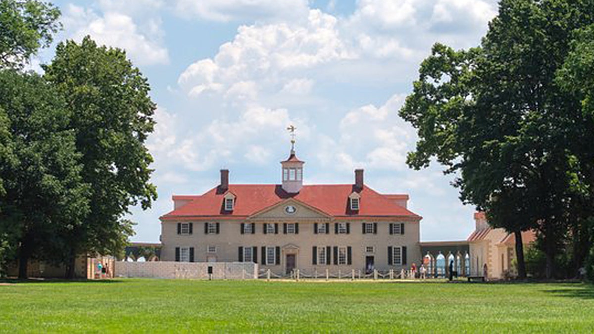 George Washington’s Mount Vernon estate with blue sky and lawn in front