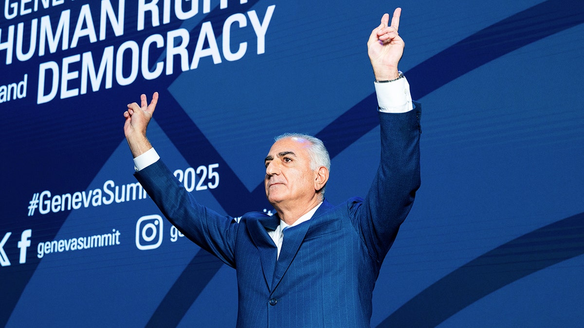 Iranian Crown Prince Reza Pahlavi waves to a crowd in Geneva