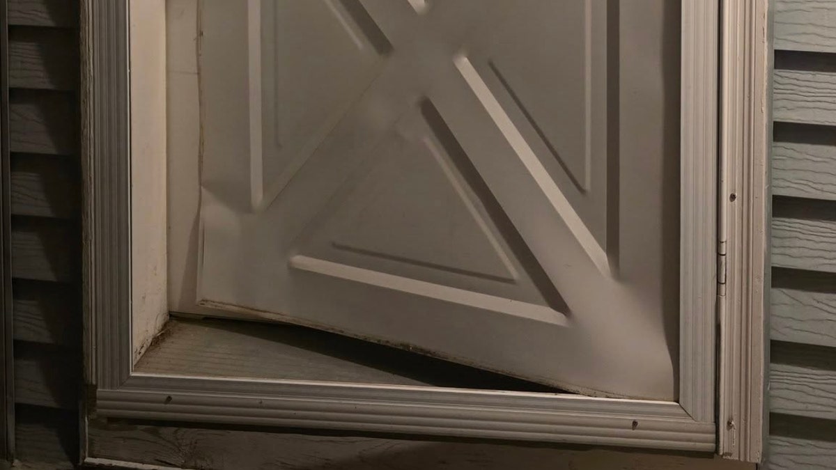 The damaged bottom of a person's door after becoming victim to the TikTok door-kick challenge