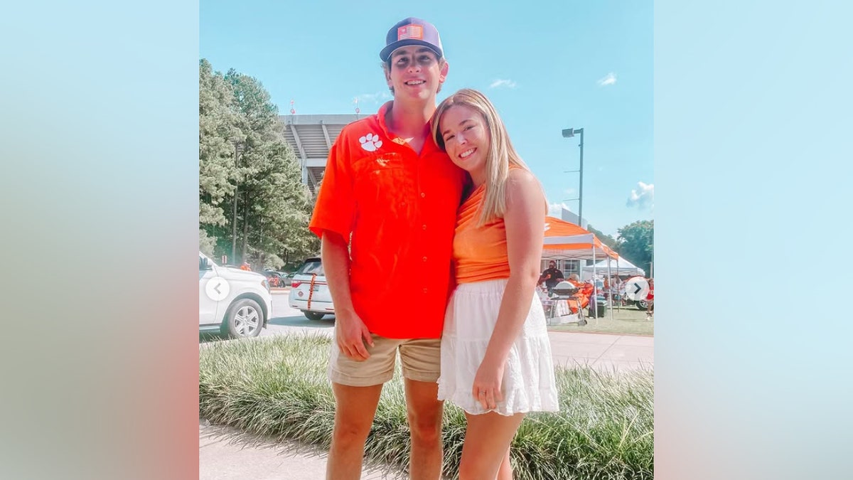 Abby Davis and Thomas Davis wearing orange Clemson outfits