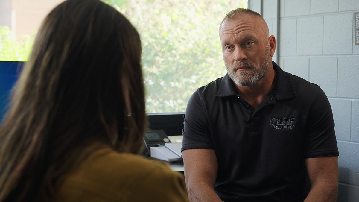 Mason City Police Investigator Terrance Prochaska sitting with Maria Awes.