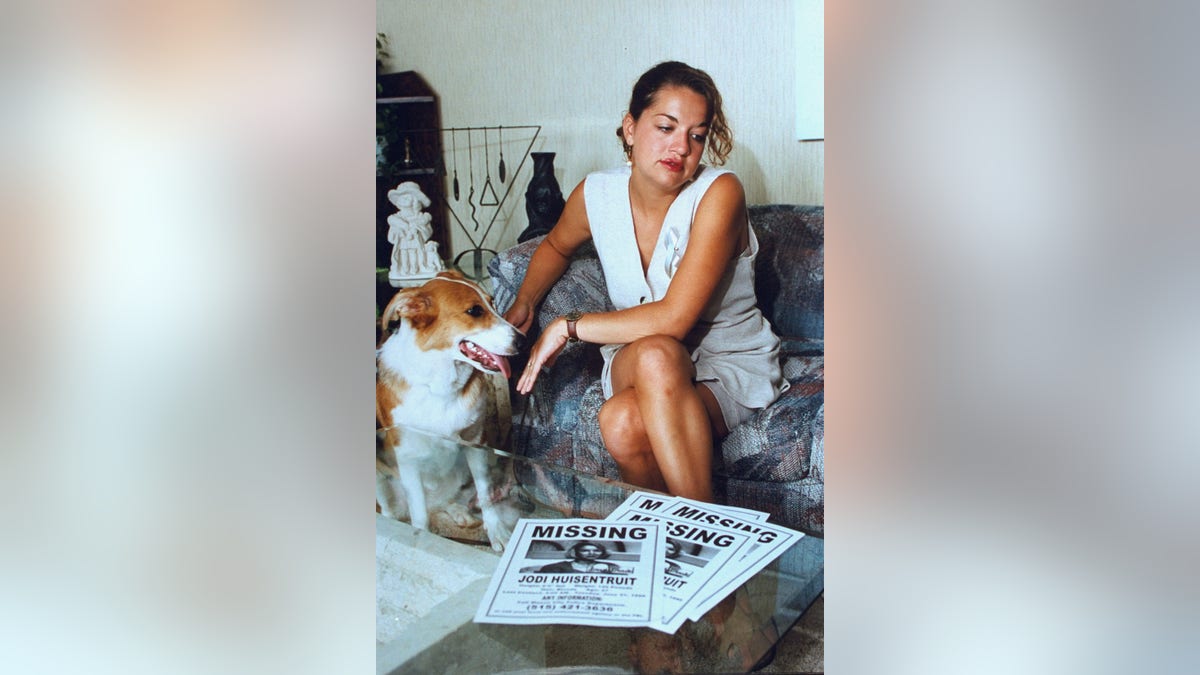 Jodi Huisentruit's friend wearing white next to her dog.