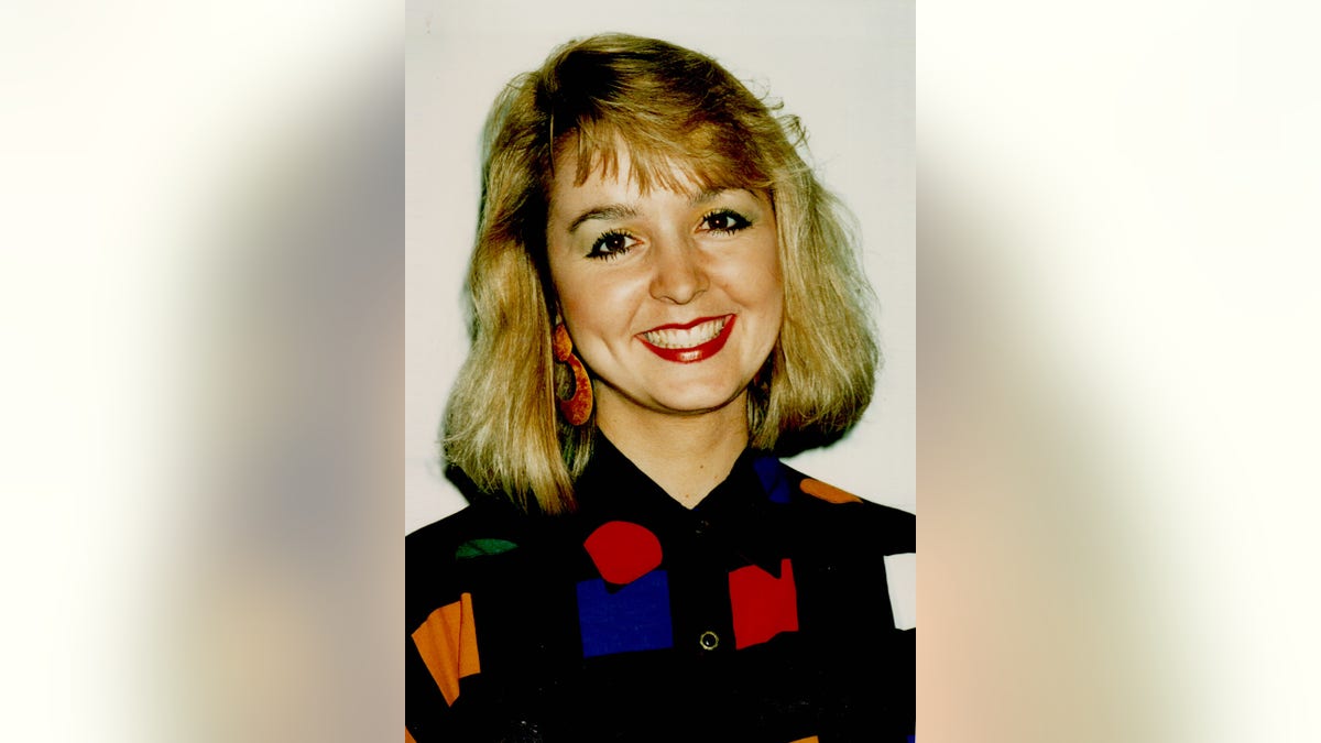 Jodi Huisentruit wearing a black dress with color prints.