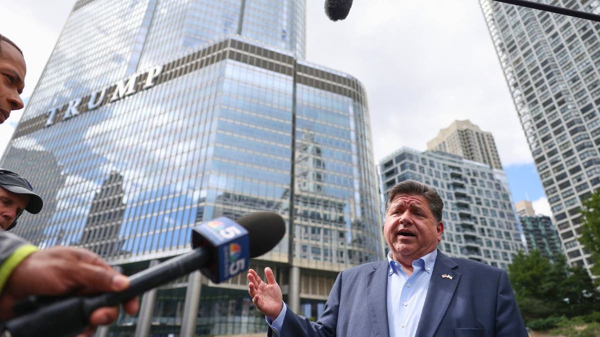 Illinois Gov. J.B. Pritzker speaks to reporters outside Trump Tower in Chicago