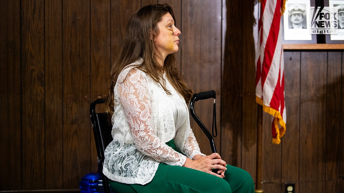 Holly, a victim in the viral July 26 brawl in Cincinnati, listens as Sen. Bernie Moreno speaks