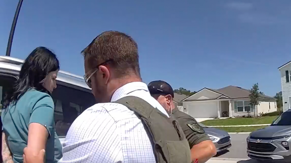 Autumn Bardisa is pictured wearing her scrubs as she's arrested