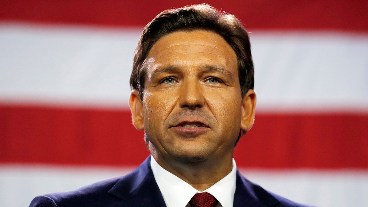 Florida Gov. Ron DeSantis in from of an American flag. 