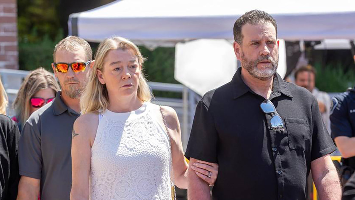 Karen Laramie holds the arm of her husband Scott Laramie as they leave the Ada County Courthouse in Boise, Idaho. They are the mother and stepfather of Madison Mogen.