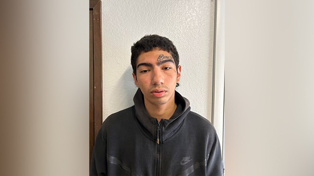 Booking photo of John Nino in black hoodie