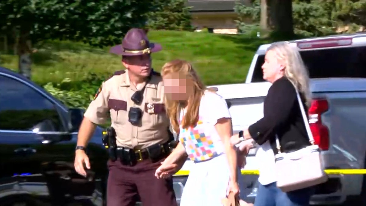 Police and woman comforting a person