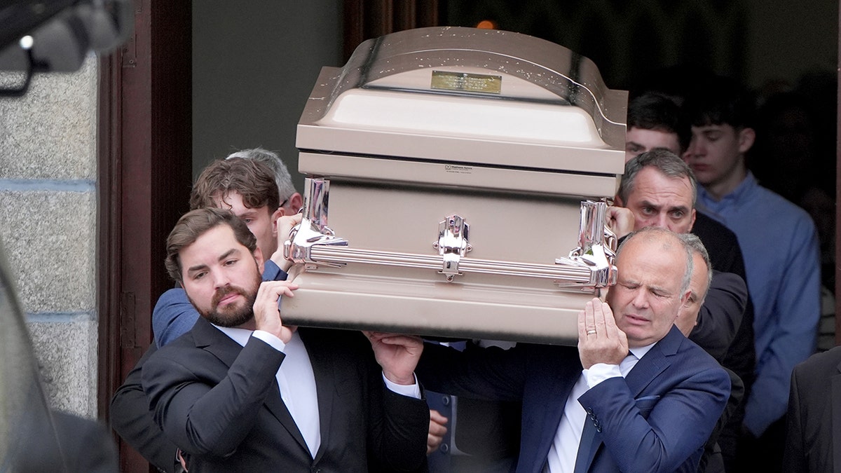 Nicholas DiRubio, left, is among the pall-bearers carrying the casket of Irish fashion designer Martha Nolan, his girlfriend, at a cathedral in Carlow, Ireland