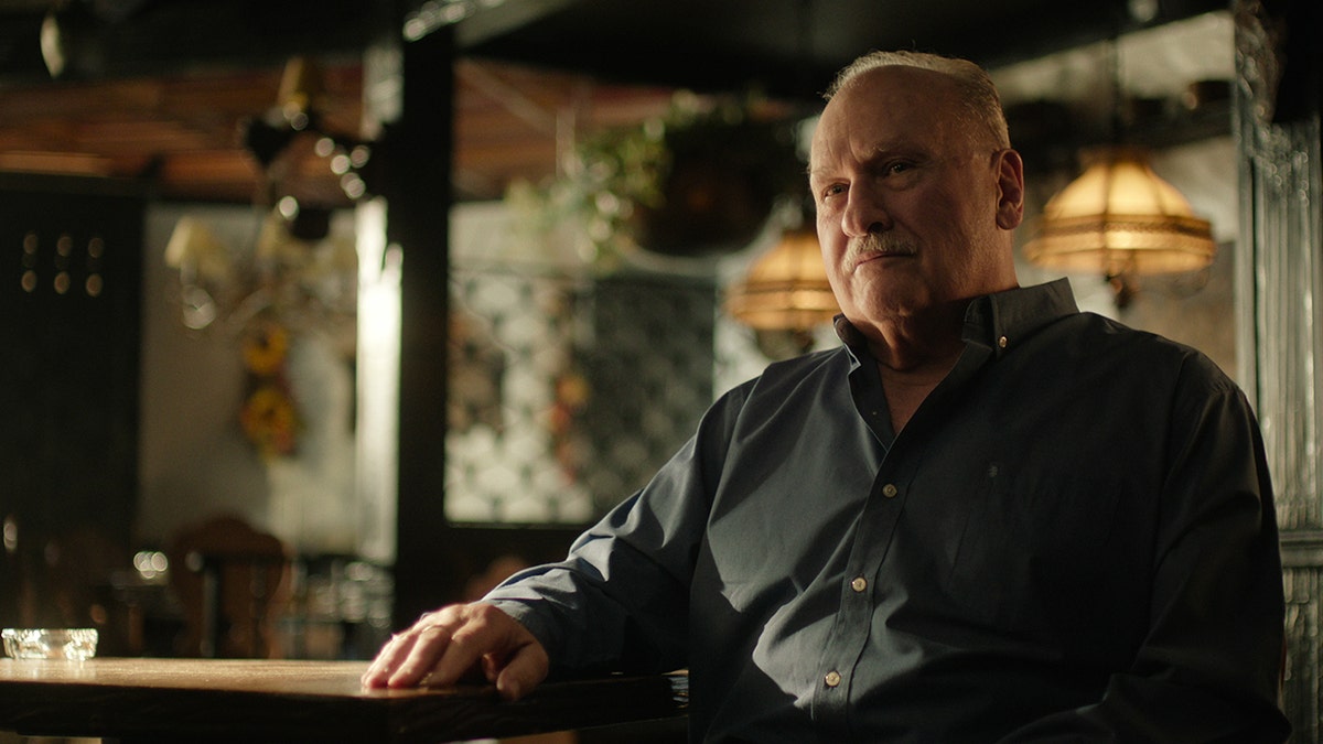 Vinny Minutolo in a blue collared shirt looking serious.