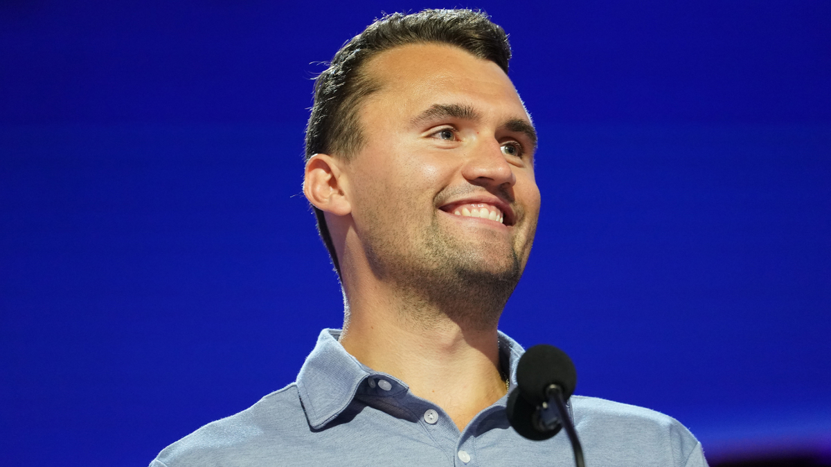 Charlie Kirk smiles onstage ahead of the Republican National Convention