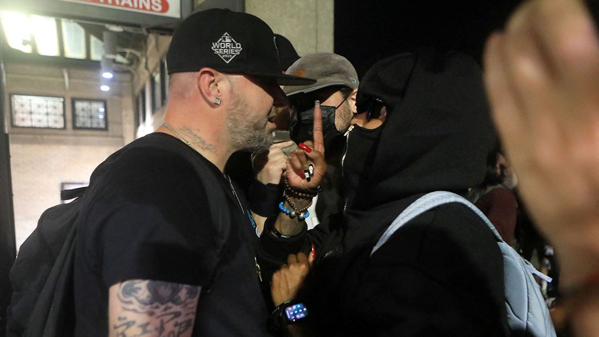 Two protesters at a Charlie Kirk vigil in Boston