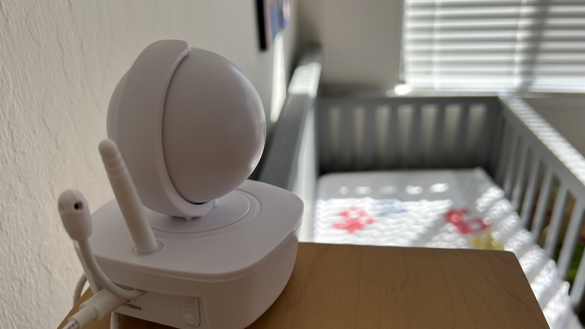 A baby monitor camera sits above a crib in a nursery in a California home.
