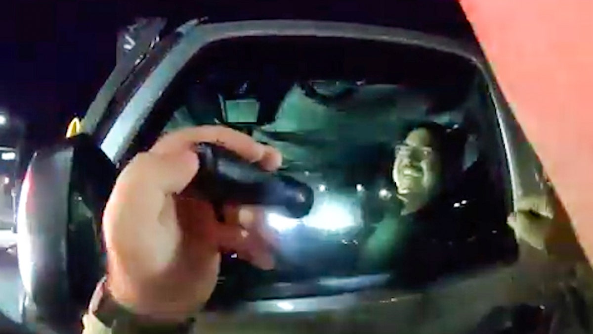 Flashlight shines into a vehicle at night