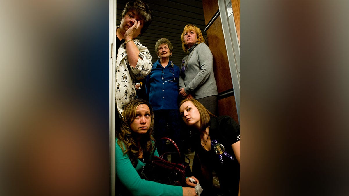 (From left to right) Charlene McLeod, Katherine McLeod, Ginger McLeod, Michelle Strick (bottom left) and Samantha McLeod, family members of victim Kaysi McLeod, listen to a recording of Scott Lee Kimball's court hearing at the Boulder County Justice center in Boulder, Colorado, Thursday, Oct. 8, 2009. Kimball pleaded guilty to the murder of four people and was sentenced to 70 years in prison.