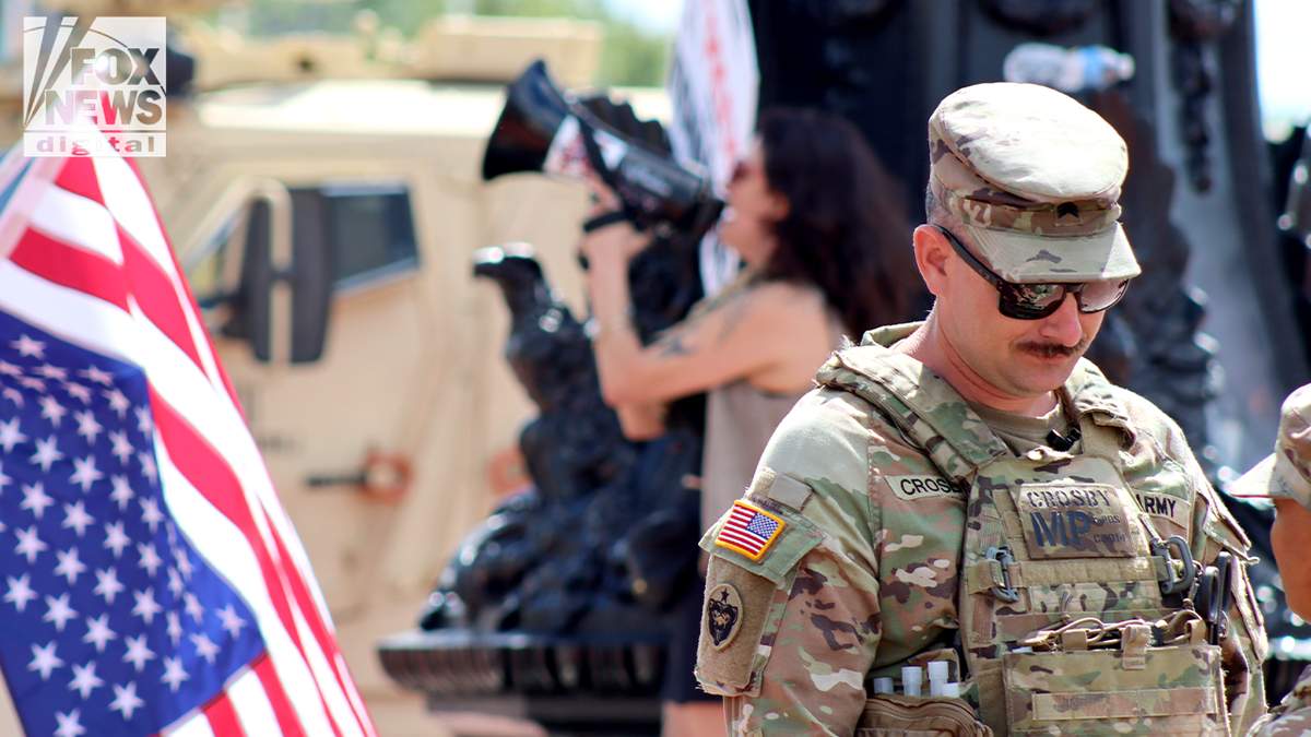 national guard stand near protesters