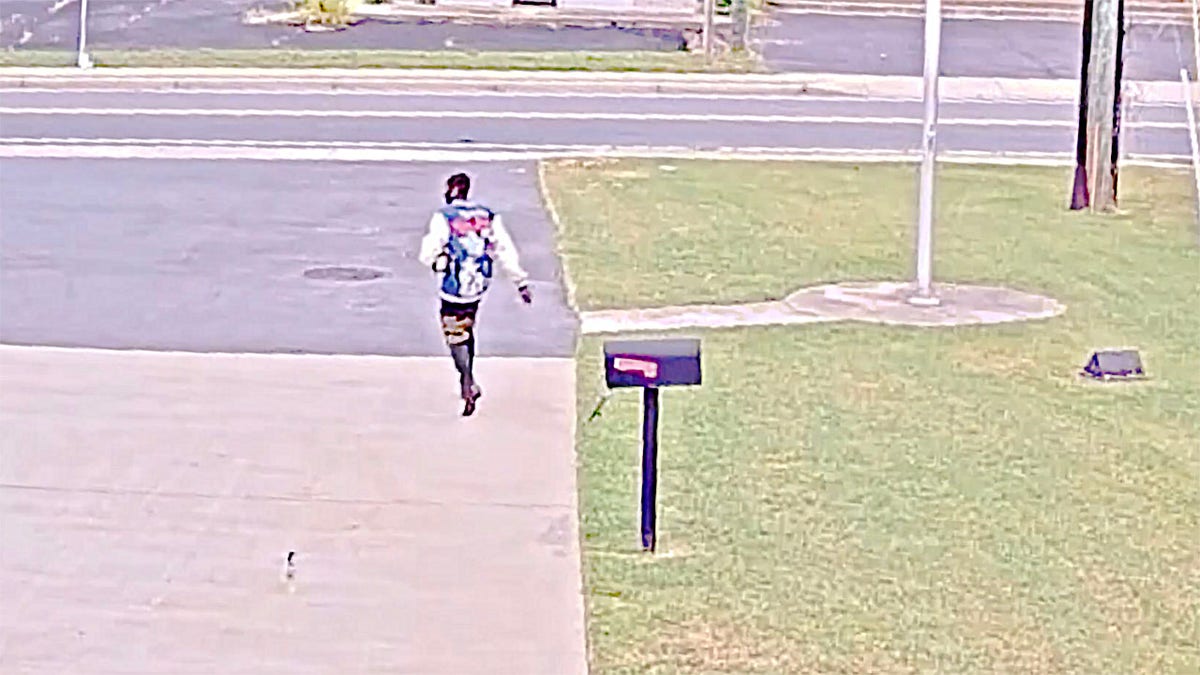 Slater Chaia members only jacket walks away from fire station