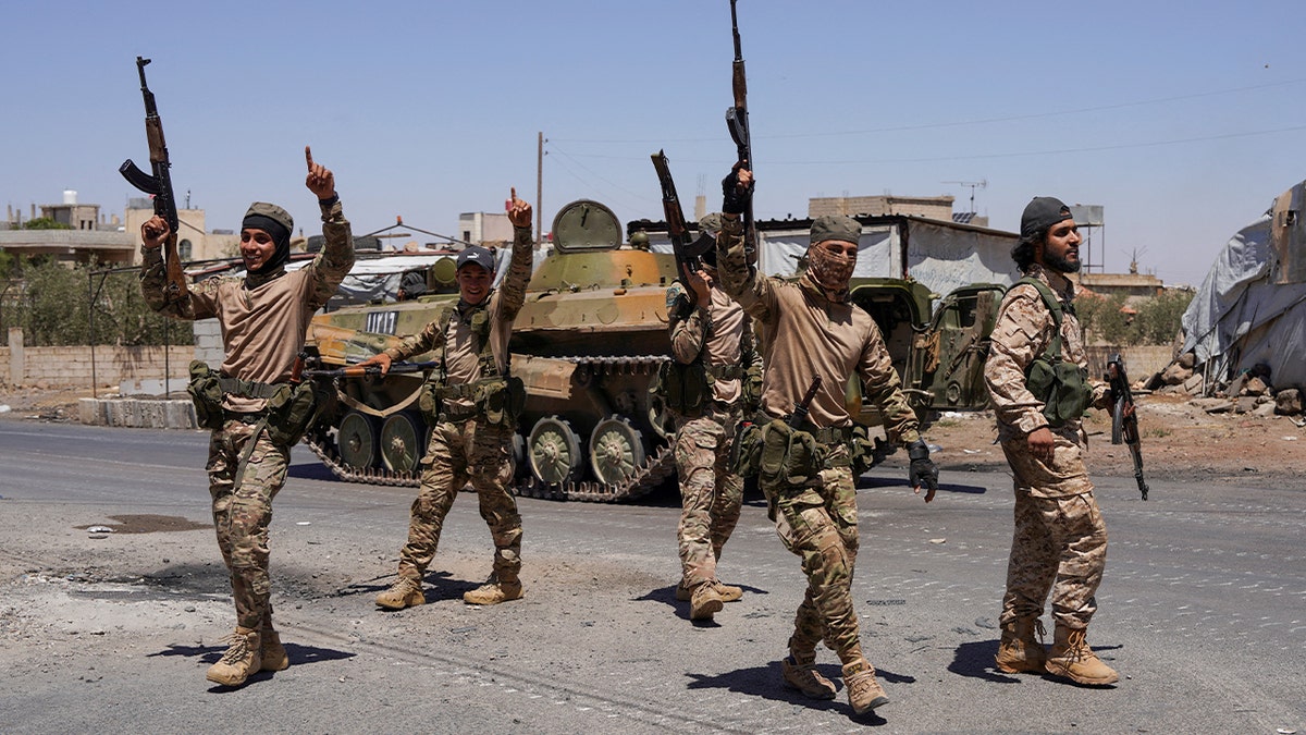 Syrian security forces walk together along a street, after clashes between Syrian government troops and local Druze fighters resumed in the southern Druze city of Sweida early on Wednesday, collapsing a ceasefire announced just hours earlier that aimed to put an end to days of deadly sectarian bloodshed, in Sweida, Syria, July 16, 2025. 