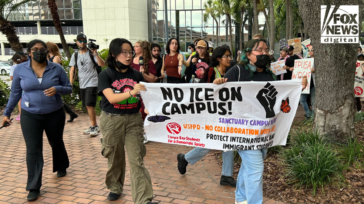 Protesters holding anti-ICE signs