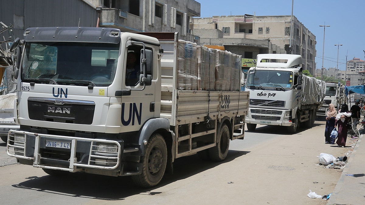 Aid trucks of the United Nations Relief and Works Agency for Palestinian Refugees in the Near East (UNRWA) deliver aid near Gaza City. 