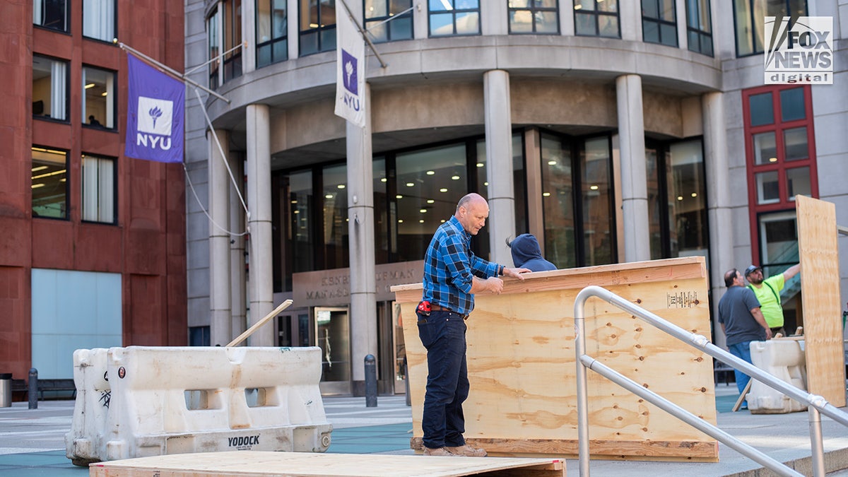 A barrier is constructed outside of New York University’s Stern School of Business in April 2024. The wall comes a day after over 100 individuals were arrested at a pro-Palestinian protest outside of the school.