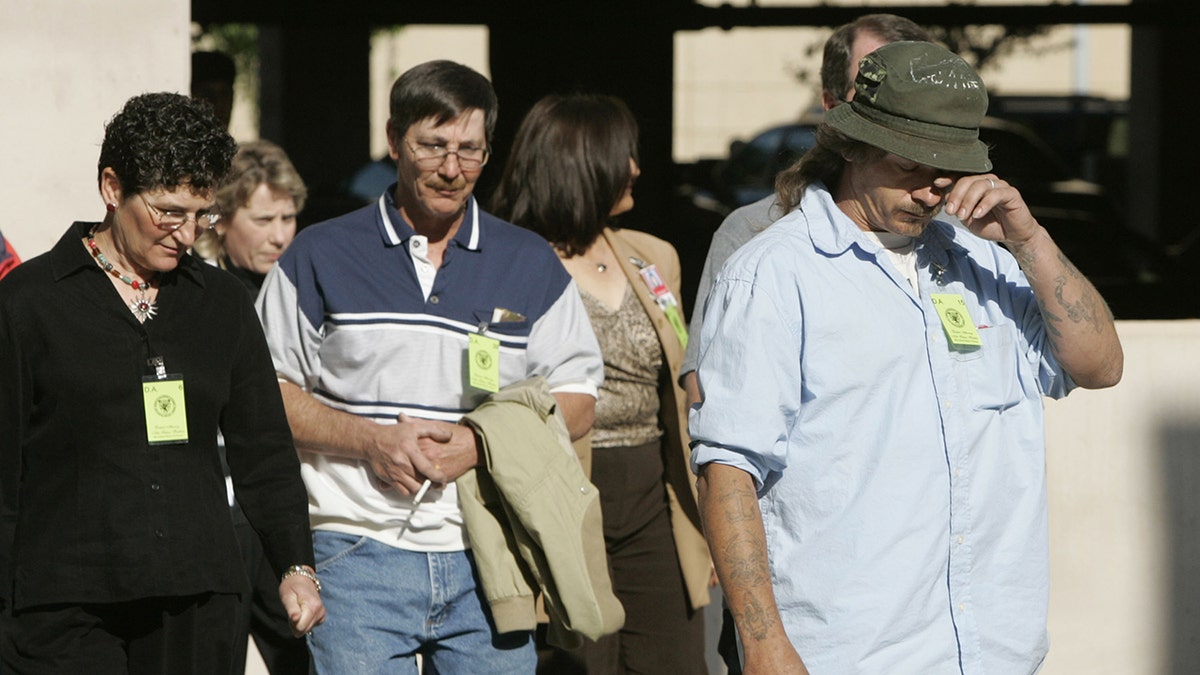 Loved ones of BTK's victims walking to court looking somber.