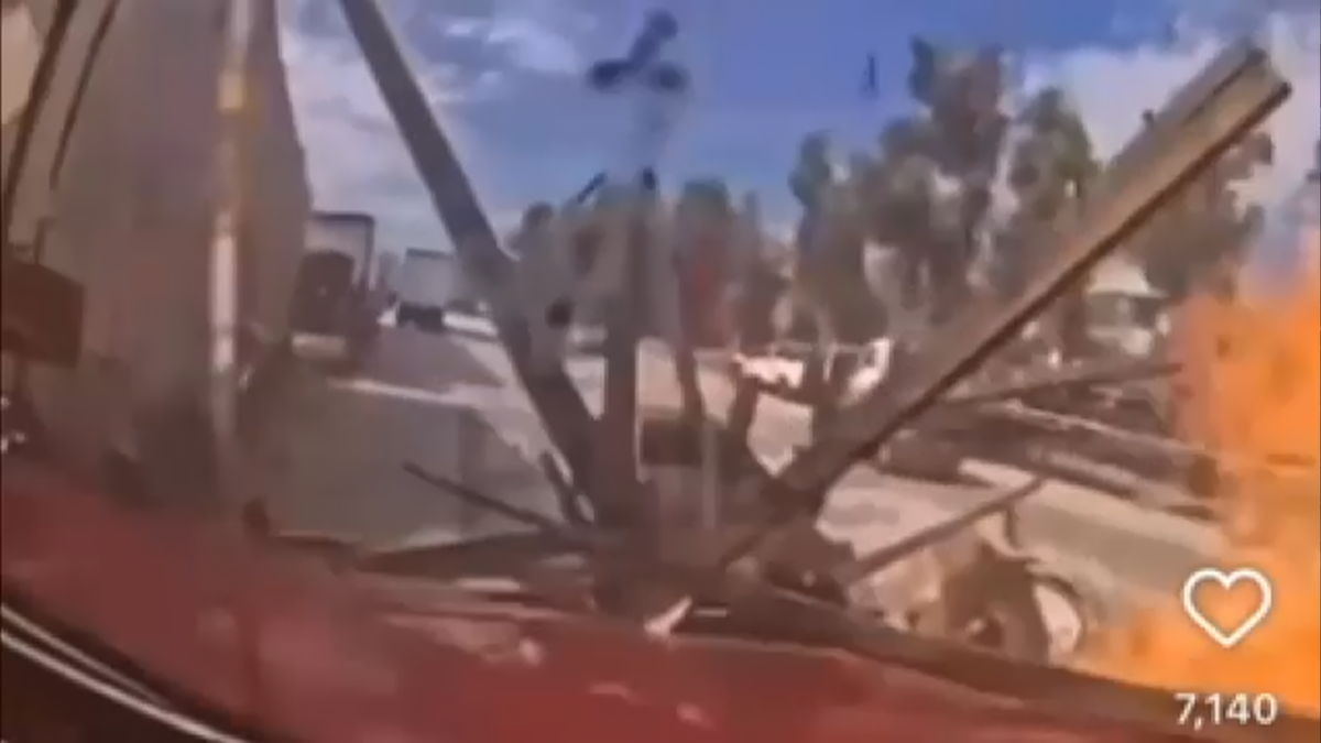 Flames erupt from the hood of a red tractor-trailer during a crash in California seen in this still image taken from video