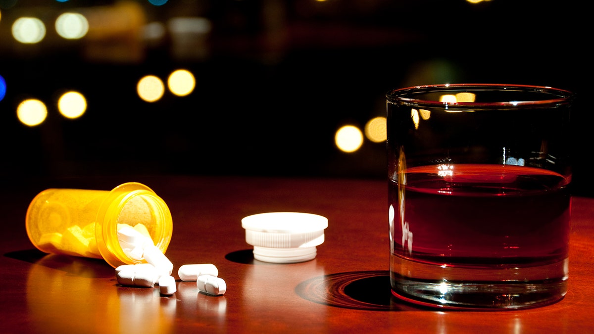 Pills next to a beverage