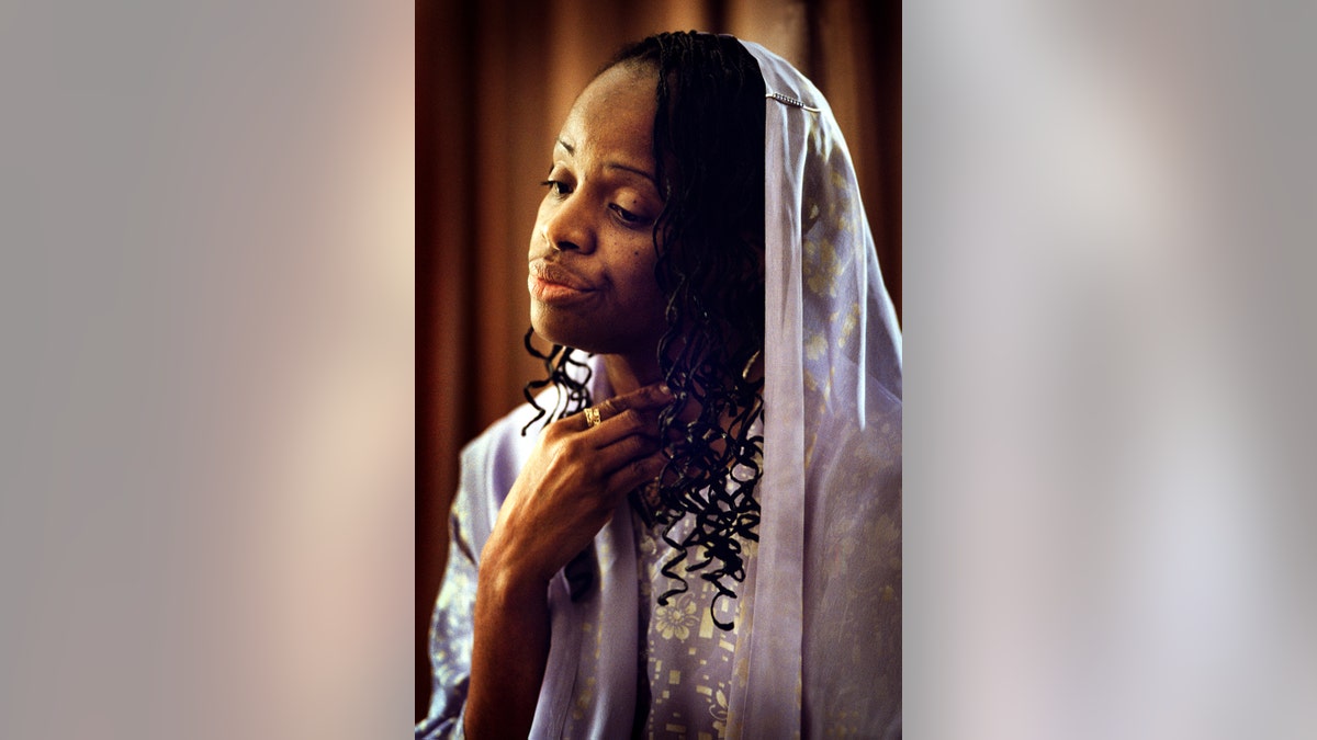 Mildred Muhammad looking somber and away from the camera.