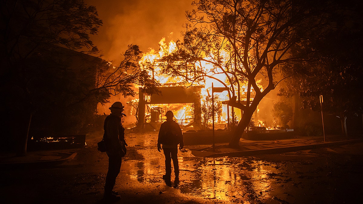 Firefighters watch Palisades Fire consume a home
