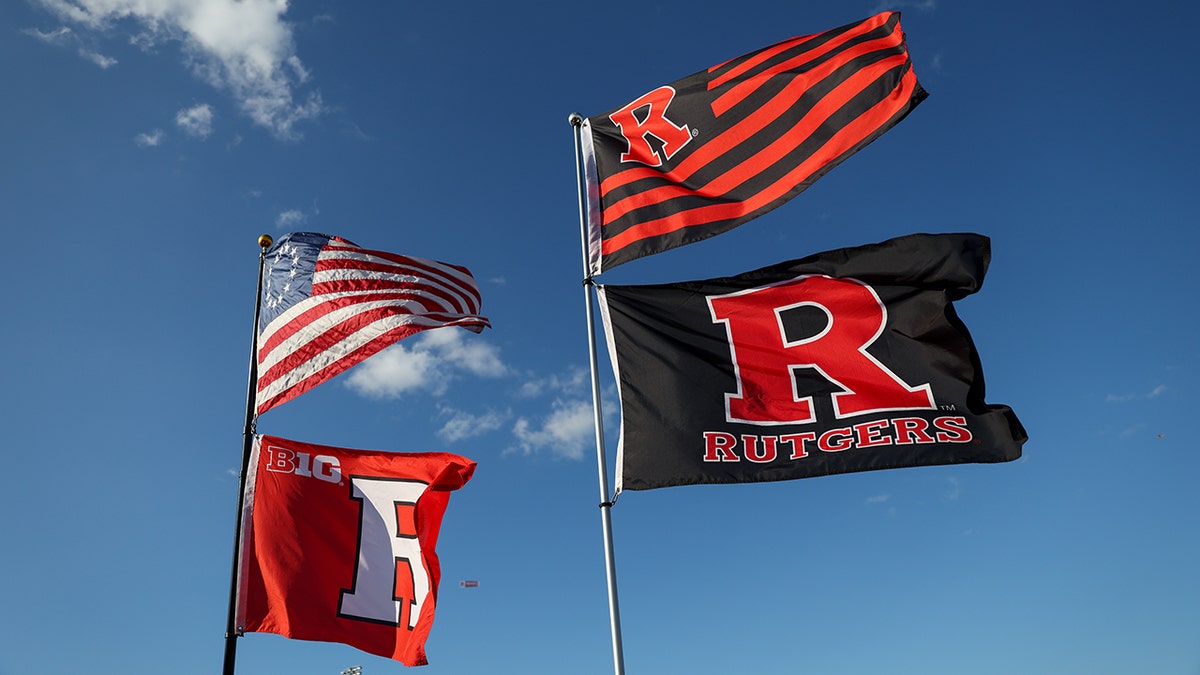 Rutgers University flags fly alongside the American flag