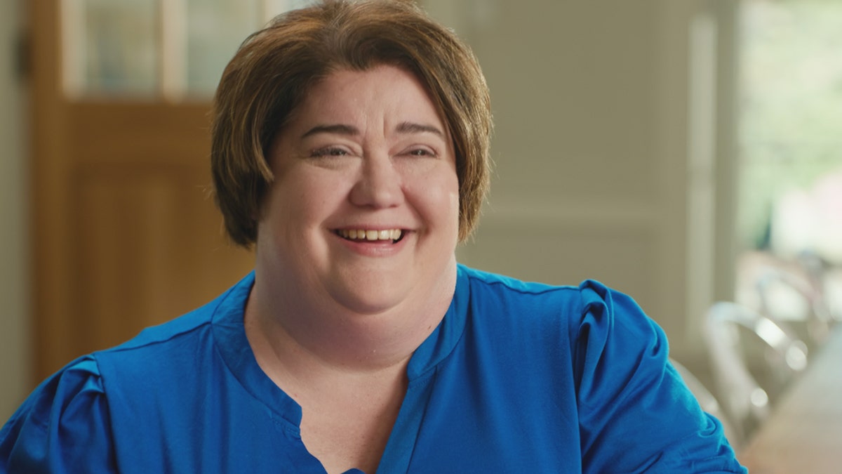 Stacey Rutherford wearing a blue blouse.