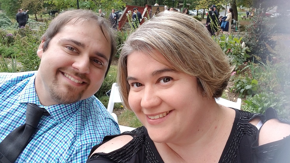 Justin Rutherford in a suit next to Stacey Rutherford smiling in a selfie.