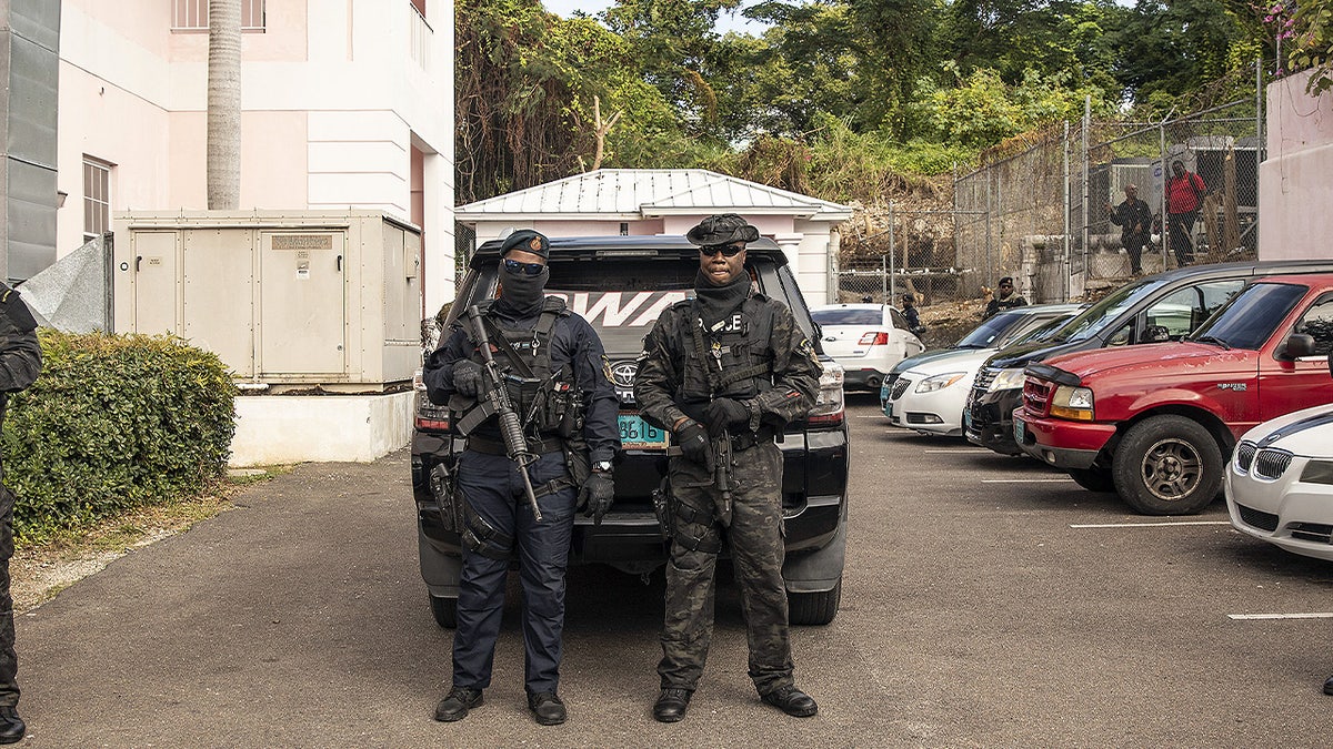 Two members of the Royal Bahamas Police Force Swat team guard outside the Magistrate's Court