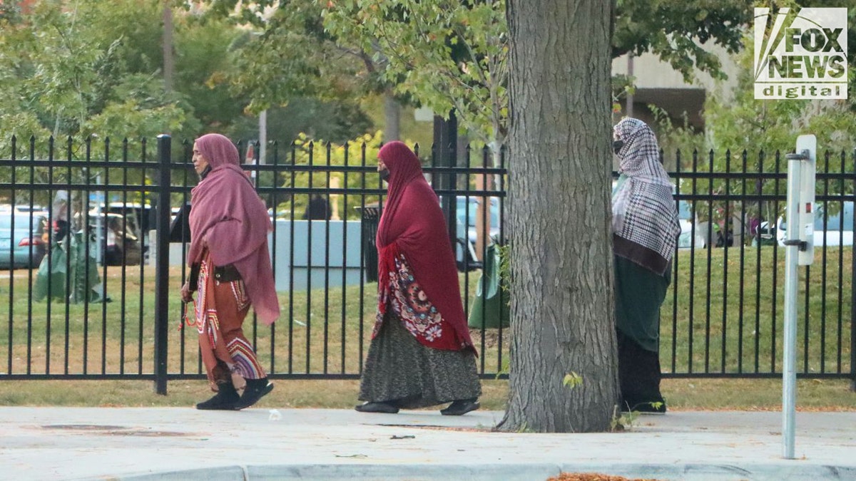 Women wearing hijabs walking near Riverside Plaza in Minneapolis
