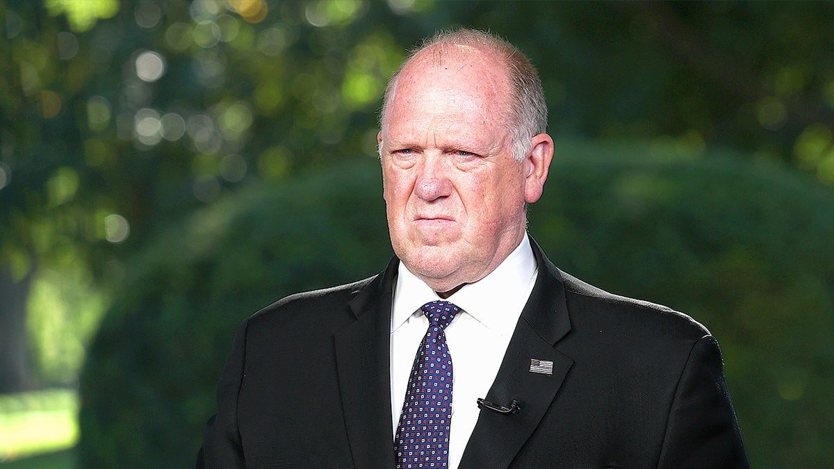 Tom Homan answer questions from reporters outside the White House.