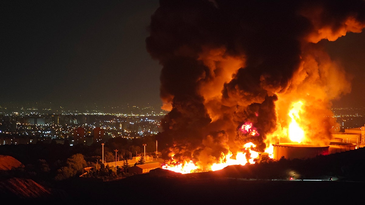 Fire and smoke rise from an Iranian oil depot
