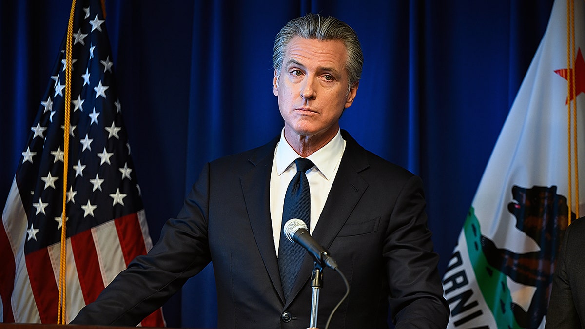 Governor Gavin Newsom makes tense facial expression at press conference