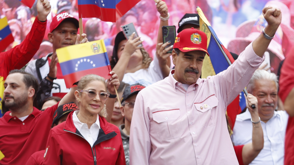 Venezuelan President Nicolas Maduro greets his supporters during a rally in Caracas on December 1, 2025.