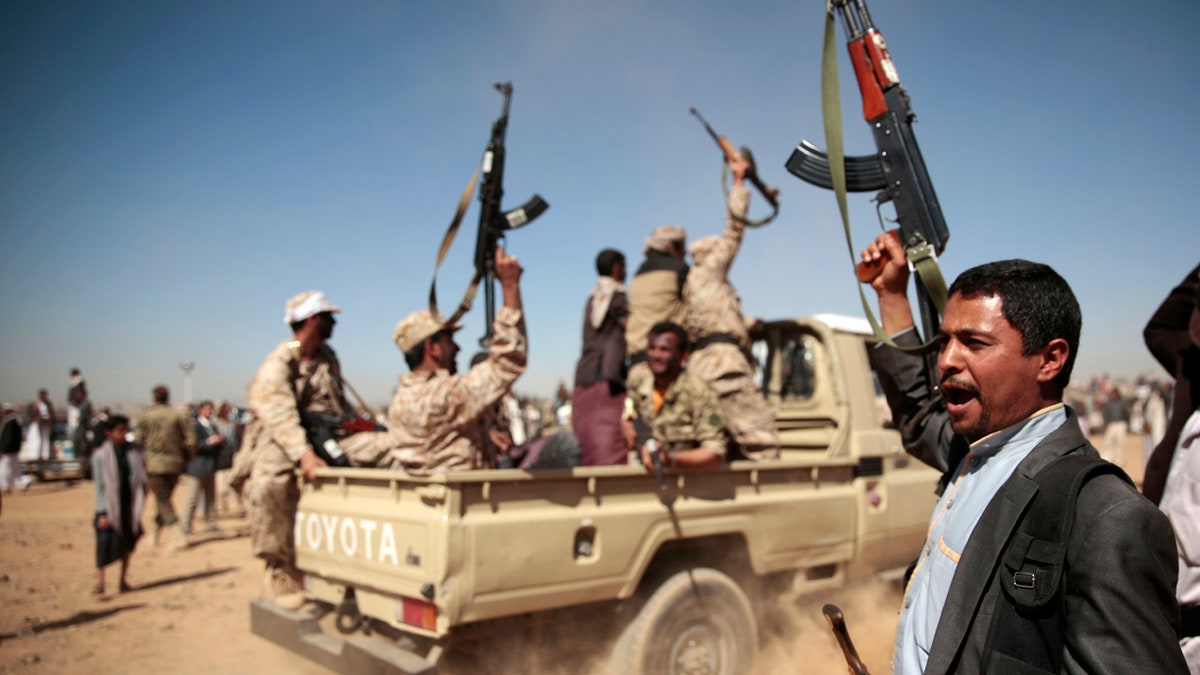 FILE - In this Jan. 3, 2017 file photo, tribesmen loyal to Houthi rebels chant slogans during a gathering aimed at mobilizing more fighters into battlefronts to fight pro-government forces, in Sanaa, Yemen. Yemenis in the war-torn country's capital crowded into basements overnight, Monday Dec. 4, 2017, as Saudi-led fighter jets pounded the positions of Houthi rebels, who are now fighting forces loyal to former Yemeni President Ali Abdullah Saleh for control of the city. A Sanaa-based protection and advocacy adviser for the Norwegian Refugee Council said Monday that the violence left aid workers trapped inside their homes and was "completely paralyzing humanitarian operations." (AP Photo/Hani Mohammed, File)