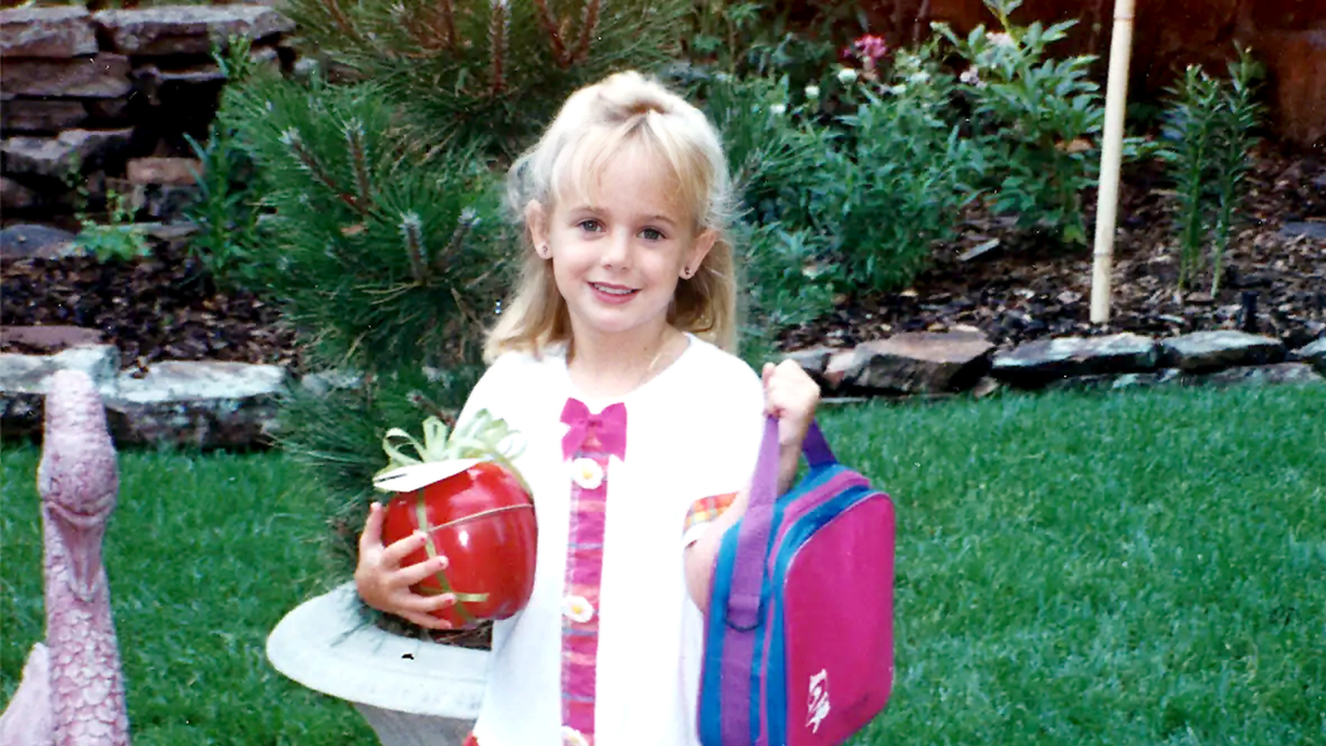 JonBenét Ramsey, holding a backpack, was a 6-year-old child whose 1996 murder inside her Colorado, home shocked the nation. Nearly three decades later, her family says advances in DNA testing bring renewed hope that the mystery surrounding her death could finally be solved.