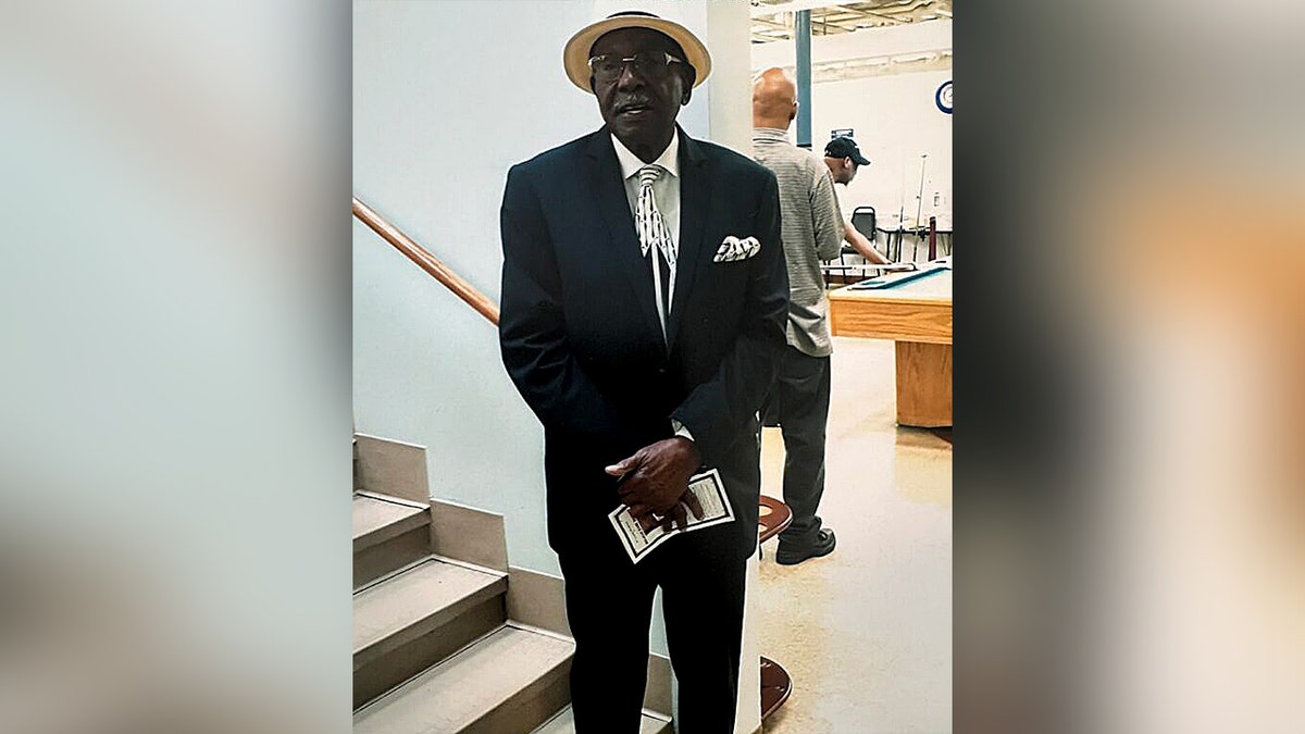 man in black suit and white hat