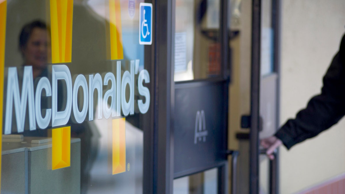 mcdonalds customer opens door to restaurant
